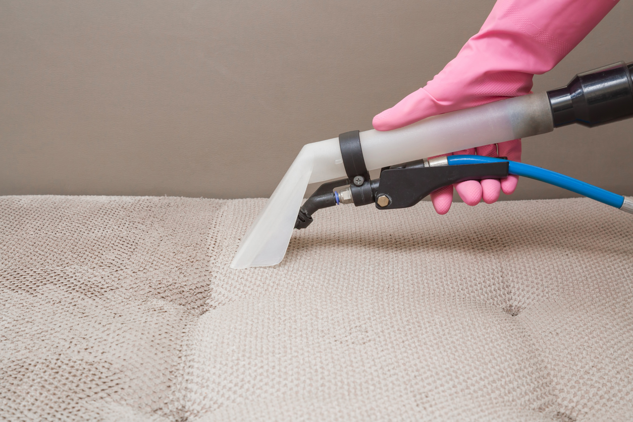 Cropped image of a mattress being cleaned to represent the signs it is time to clean your mattress.