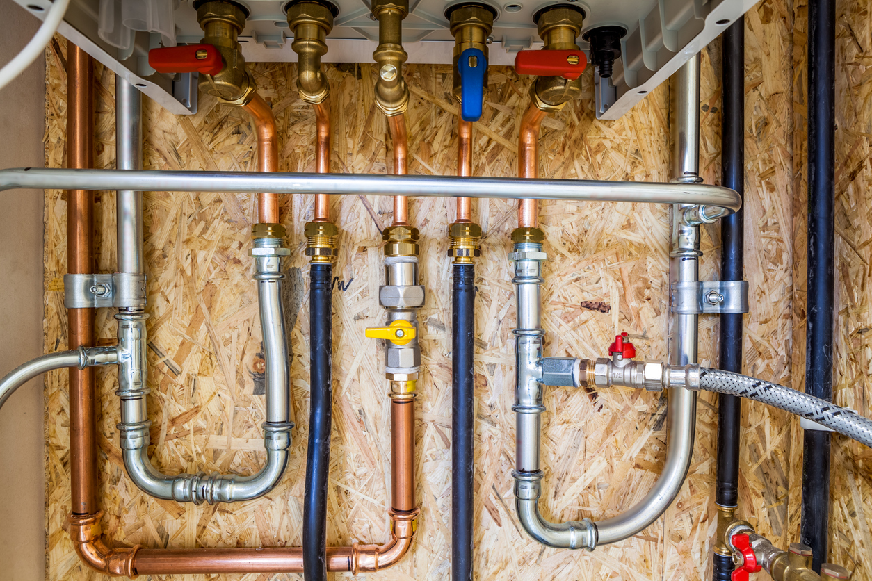 The image shows a bunch of pipes to represent the process of repiping your home.